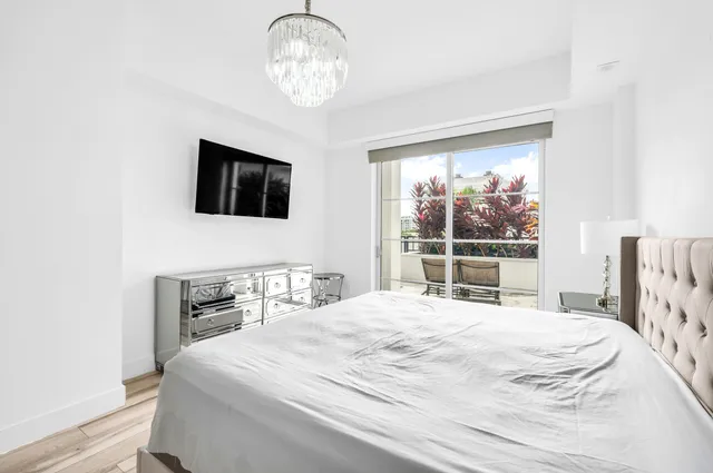 a bedroom with a large bed and a tv