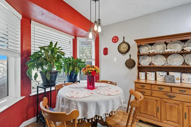 a table that has a stove and a wooden floor
