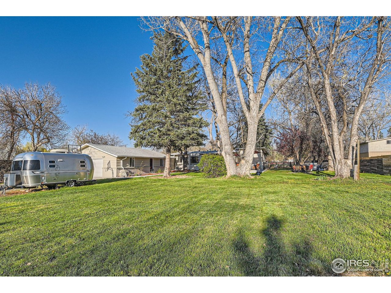 1098 Cherryvale Road Boulder, CO 80303 - Photo 3 of 28 a view of a house with a big yard and large trees