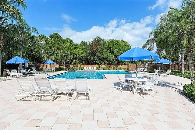 a view of a patio with a table and chairs under an umbrella