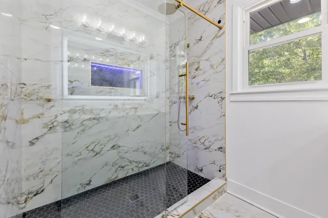 a bathroom with a bathtub and shower