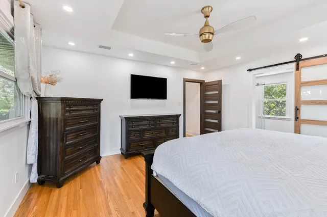 a bed room with a bed and a television