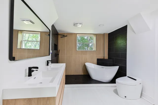 a bathroom with a toilet sink and mirror