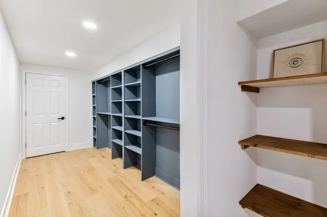 a view of walk in closet with empty racks