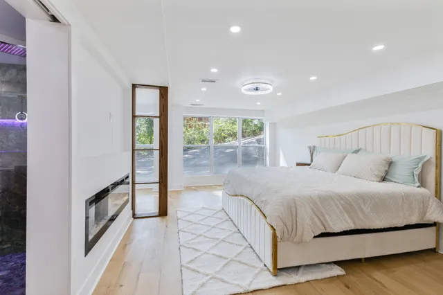 a spacious bedroom with a bed and a large window