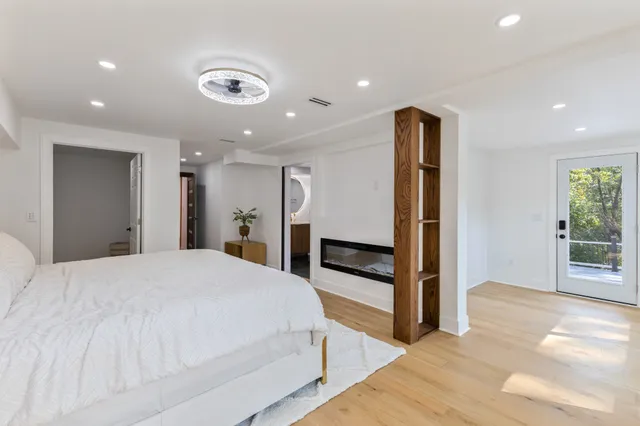 a spacious bedroom with a bed and a large window