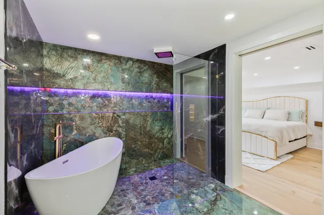 a bath room with a toilet and a bath tub