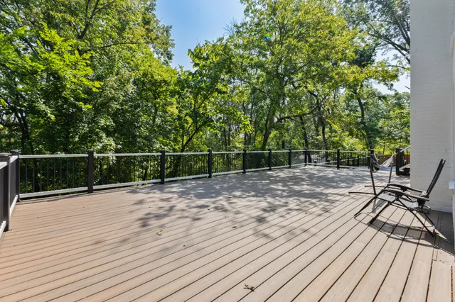 a view of a roof deck with wooden floor and fence