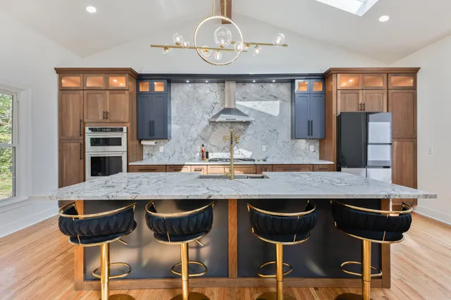 a kitchen with a kitchen island and chairs in it