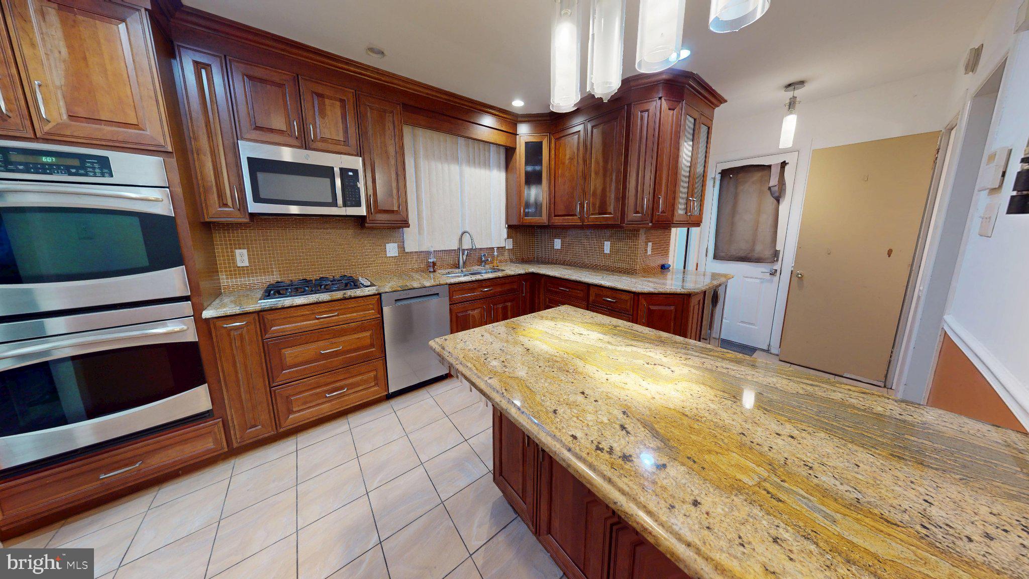 669 North Henderson Road King of Prussia, PA 19406 - Photo 14 of 84 Elegant kitchen with rich wood accents.
