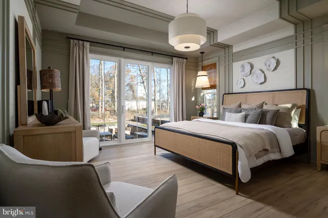 a bedroom with a large bed and a large window