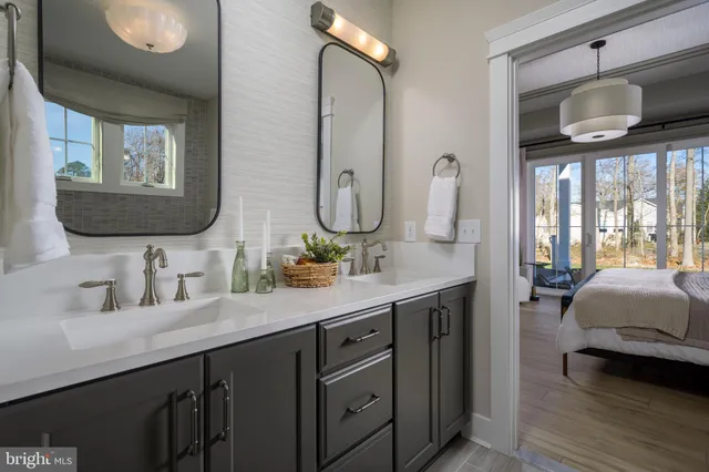 a bathroom with a double vanity sink and a mirror