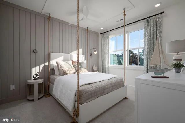 a bedroom with a bed chandelier and window