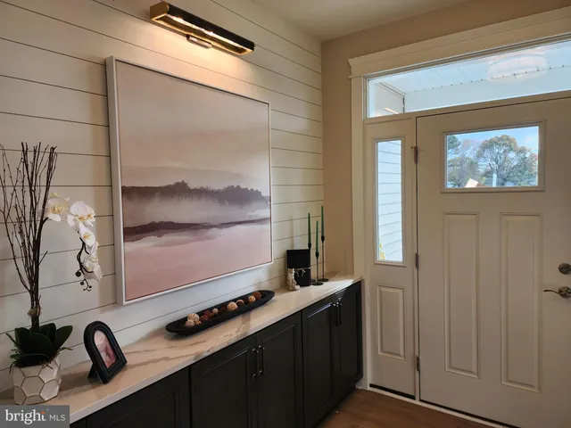 a room with wooden floor and windows