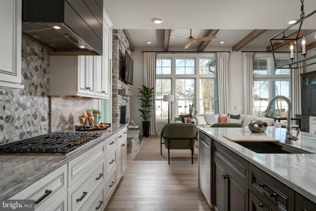a kitchen with stainless steel appliances granite countertop a sink stove and cabinets