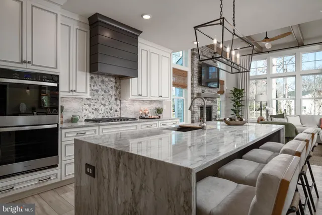 a kitchen with stainless steel appliances granite countertop a sink a stove and a microwave