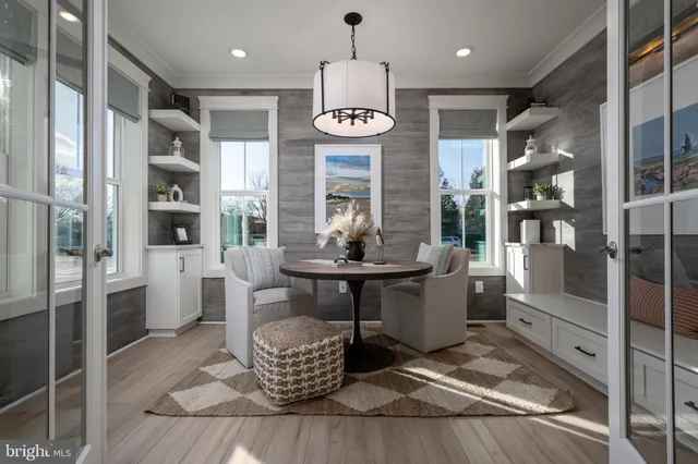 a large living room with stainless steel appliances granite countertop furniture and a fireplace