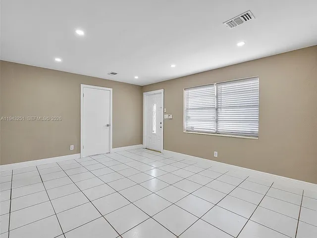 a view of an empty room and a window