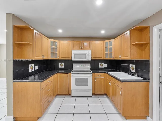 a kitchen with stainless steel appliances granite countertop a sink and cabinets