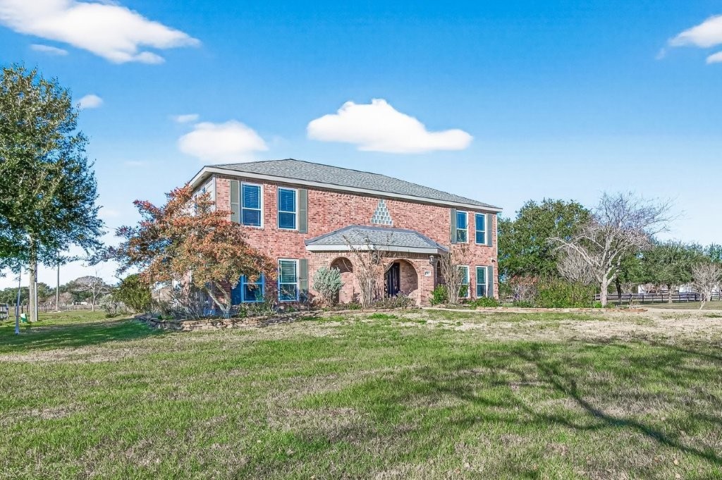 6610 Sprigg Street Fulshear, TX 77441 - Photo 6 of 49 a front view of a house with a yard