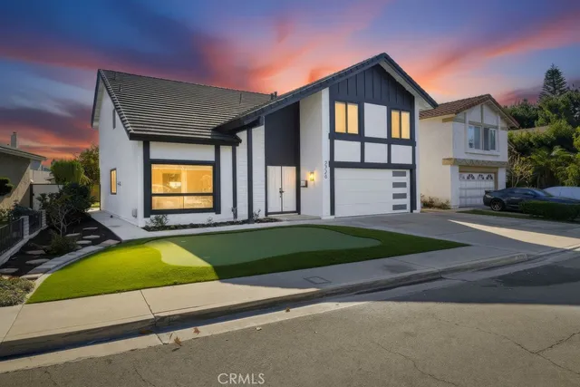 a view of a house with a swimming pool and a yard