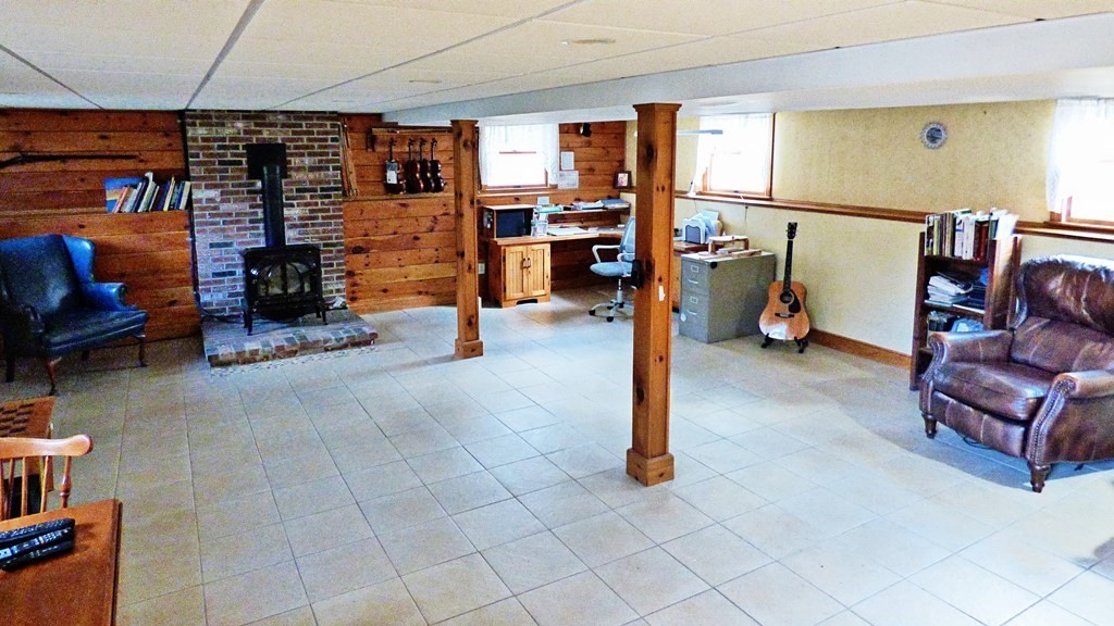 115 Richard Drive Hanover, MA 02339 - Photo 14 of 18 a living room with furniture a flat screen tv and fireplace