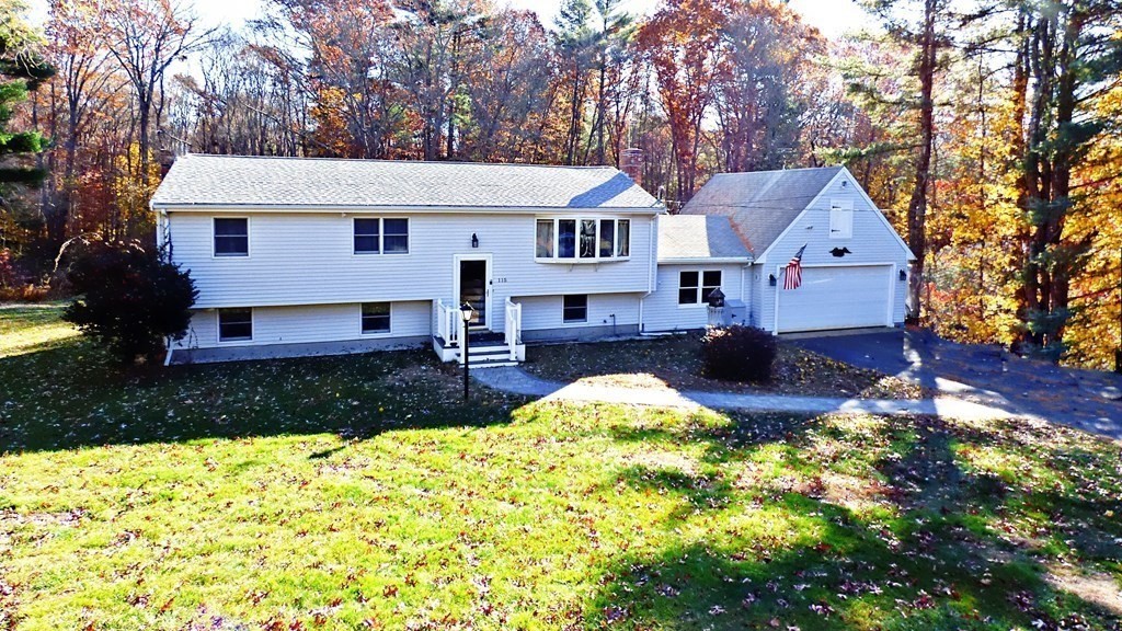 115 Richard Drive Hanover, MA 02339 - Photo 2 of 18 a front view of a house with a yard and garage