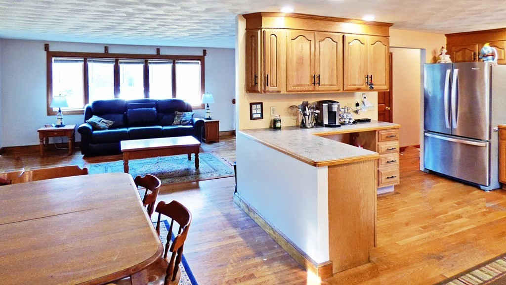 115 Richard Drive Hanover, MA 02339 - Photo 4 of 18 a kitchen with stainless steel appliances granite countertop a refrigerator a sink a stove and island