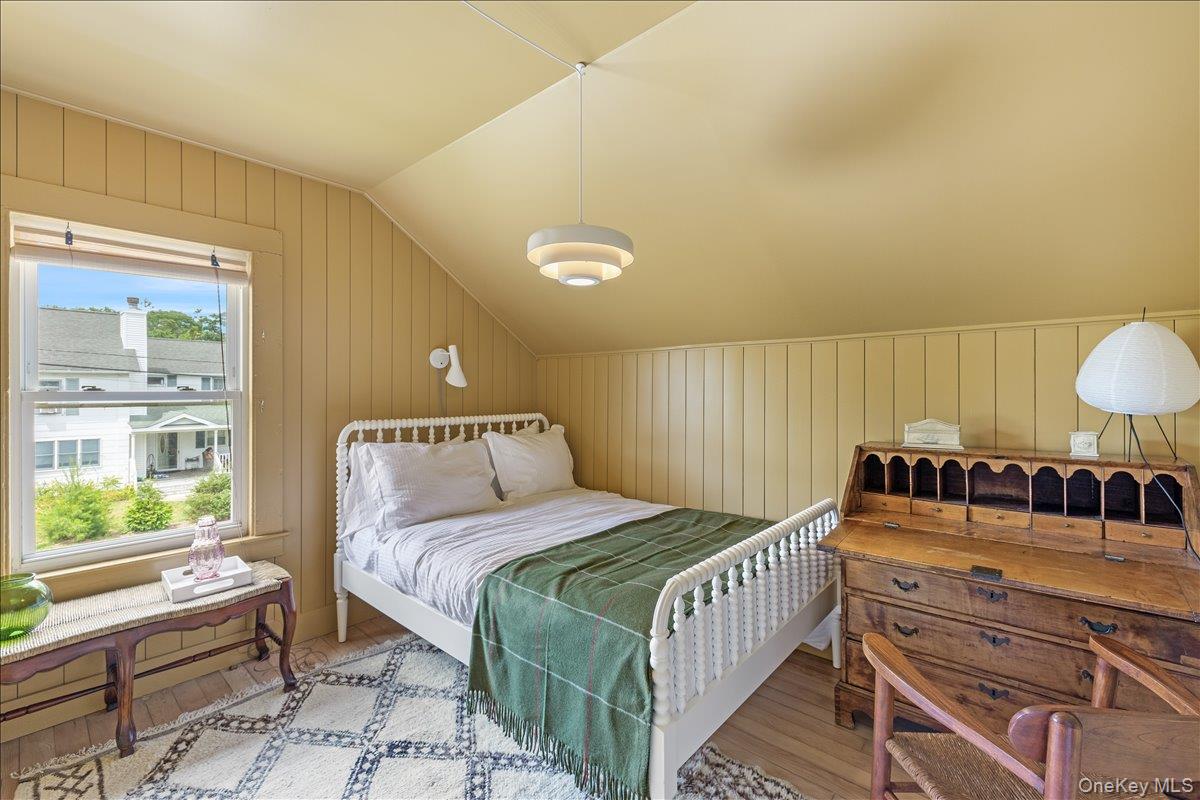 19 New Jersey Avenue Bellport, NY 11713 - Photo 17 of 17 a bedroom with a bed a mirror and a window