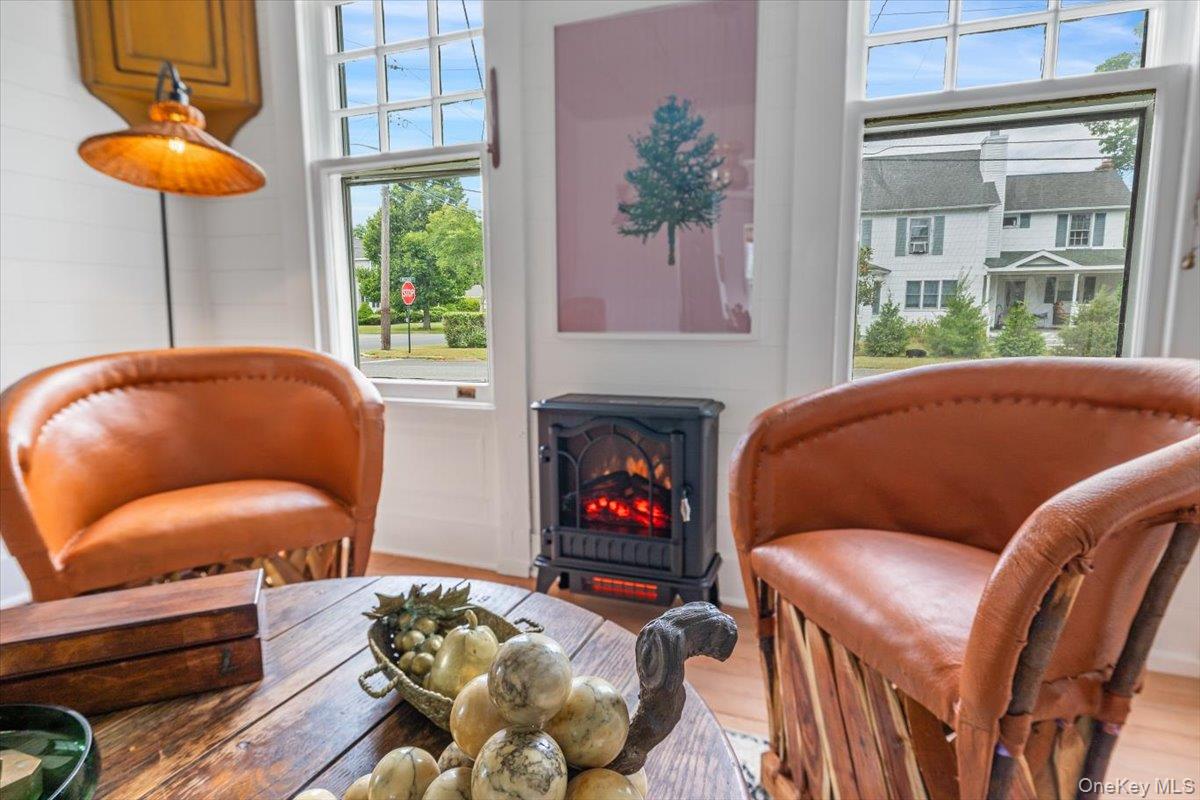 19 New Jersey Avenue Bellport, NY 11713 - Photo 9 of 17 a living room with furniture and a fireplace
