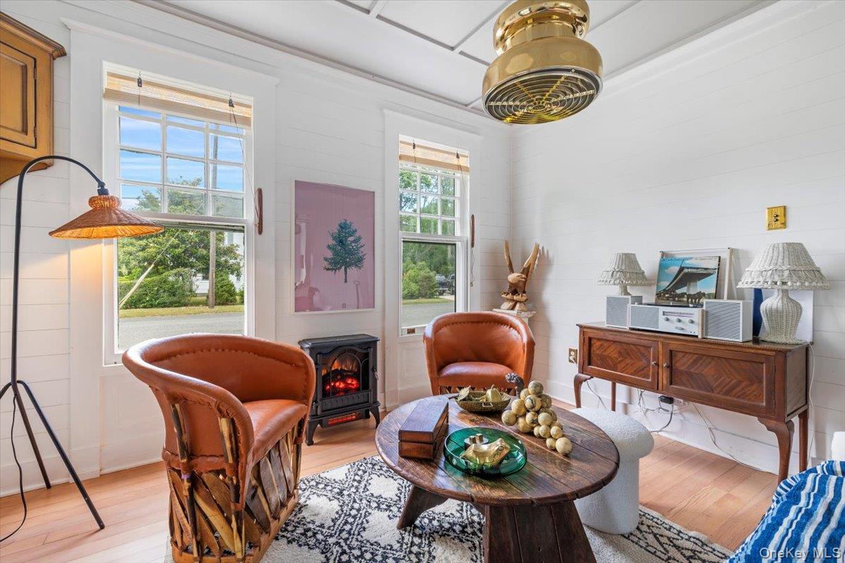 19 New Jersey Avenue Bellport, NY 11713 - Photo 10 of 17 a living room with furniture a chandelier and a window