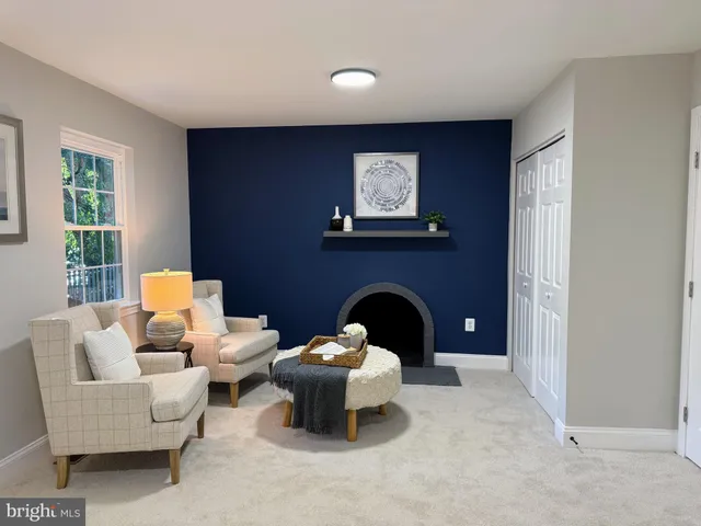 a living room with furniture a window and a fireplace