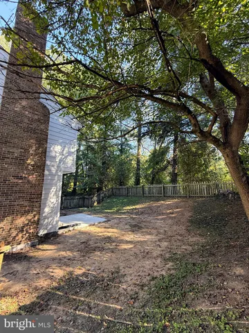 a view of backyard of house with trees