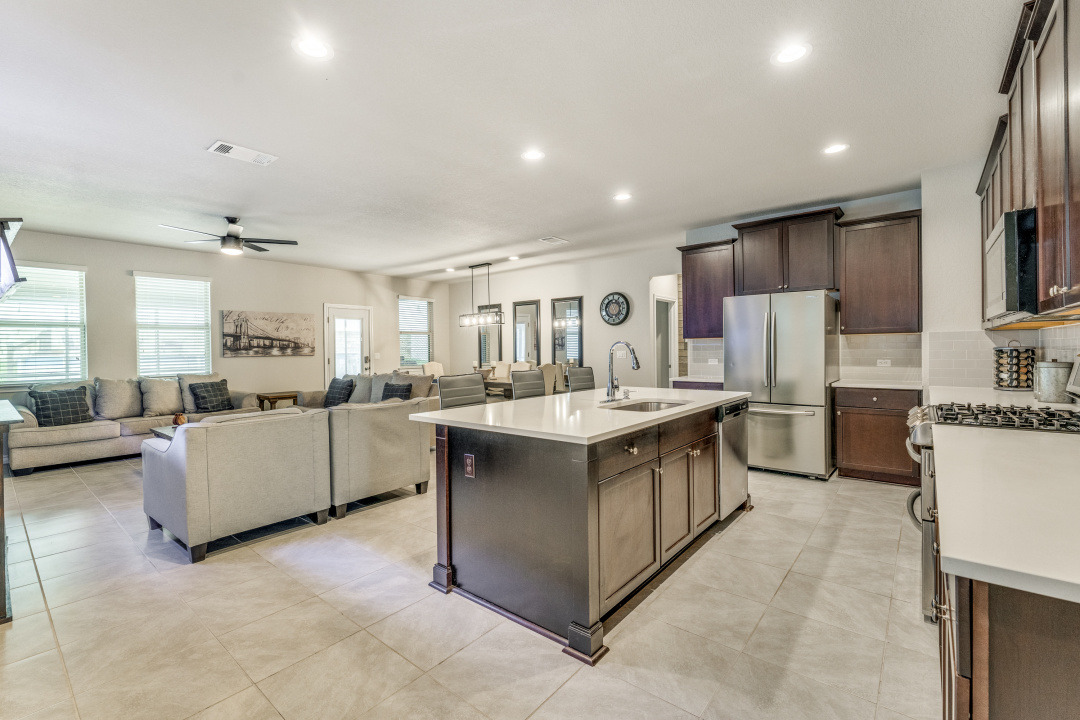 5921 Lehman Way Austin, TX 78747 - Photo 25 of 25 An open floorplan seamlessly connects the well-lit kitchen with its central island to the comfortable living area, ideal for gathering.