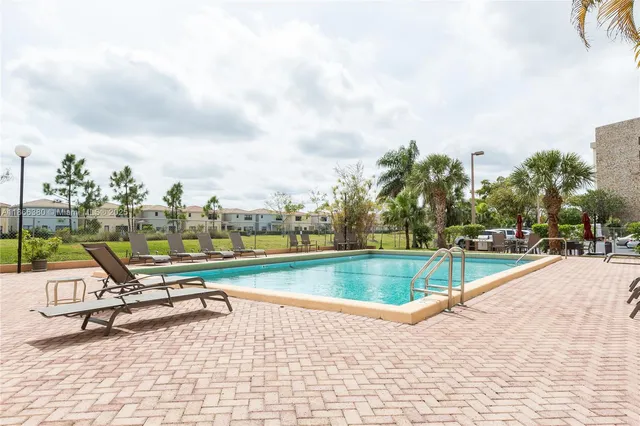 a view of a swimming pool with a lounge chair