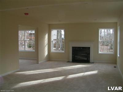 128 Withywindle Way Bushkill, PA 18324 - Photo 2 of 4 a living room with furniture and a fireplace