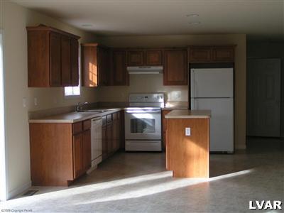 128 Withywindle Way Bushkill, PA 18324 - Photo 3 of 4 a kitchen with stainless steel appliances granite countertop a stove a sink and a refrigerator
