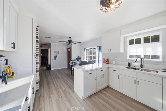 a kitchen with a sink stove and cabinets