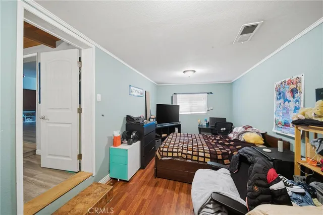a bedroom with furniture and a wooden floor