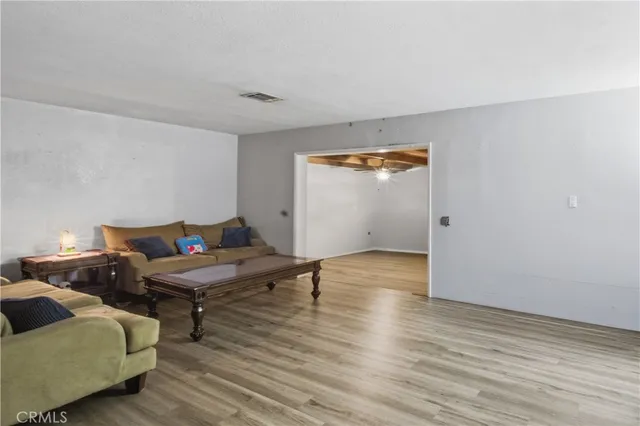 a living room with couches and painted walls with wooden floor