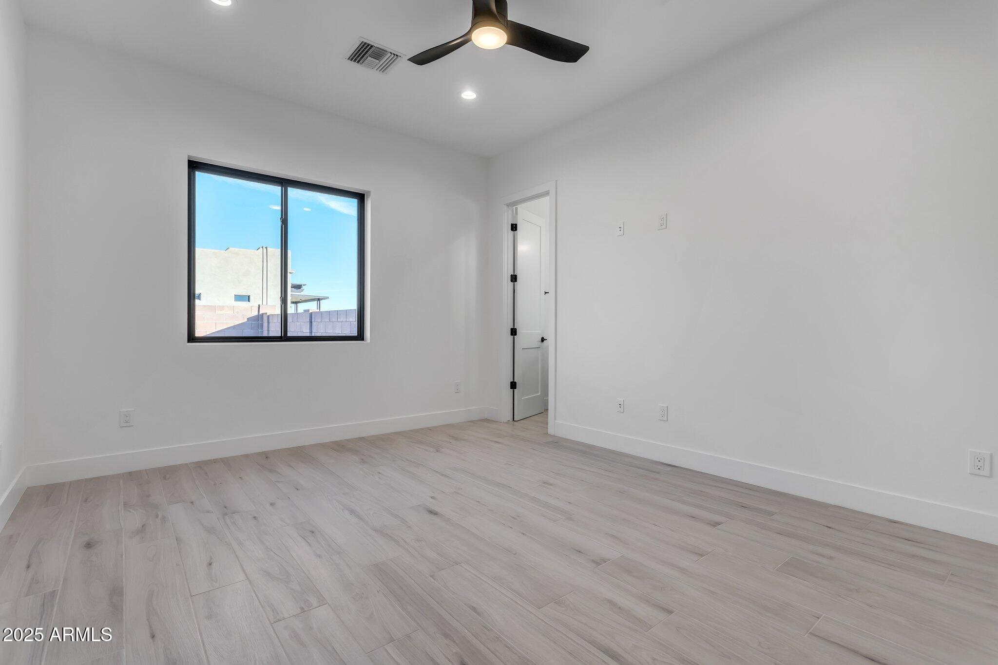 1602 East Cloud Road Phoenix, AZ 85086 - Photo 26 of 45 wooden floor in an empty room with a window