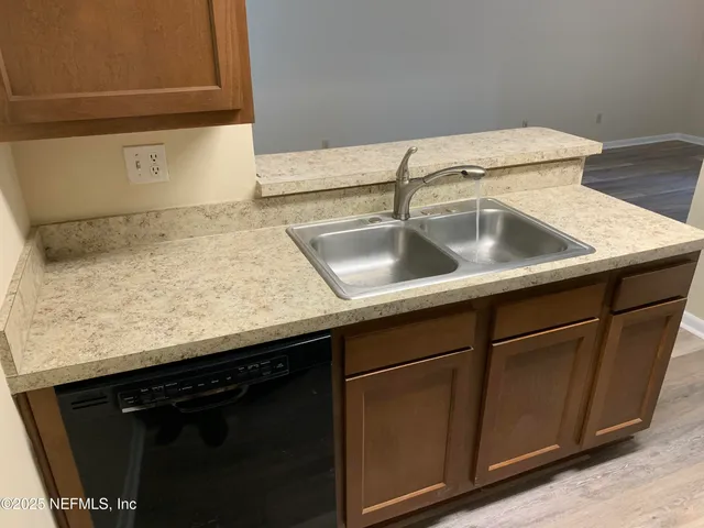 a kitchen with granite countertop a refrigerator stove and microwave