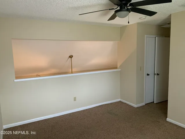 a bathroom with a granite countertop bathtub shower sink vanity and toilet