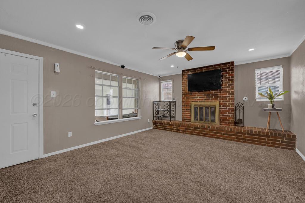 2106 South Cleveland Street Amarillo, TX 79103 - Photo 11 of 26 a view of a livingroom with a flat screen tv ceiling fan and window