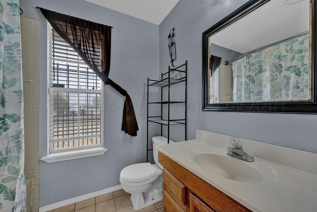 2106 South Cleveland Street Amarillo, TX 79103 - Photo 20 of 26 a bathroom with a sink toilet and window