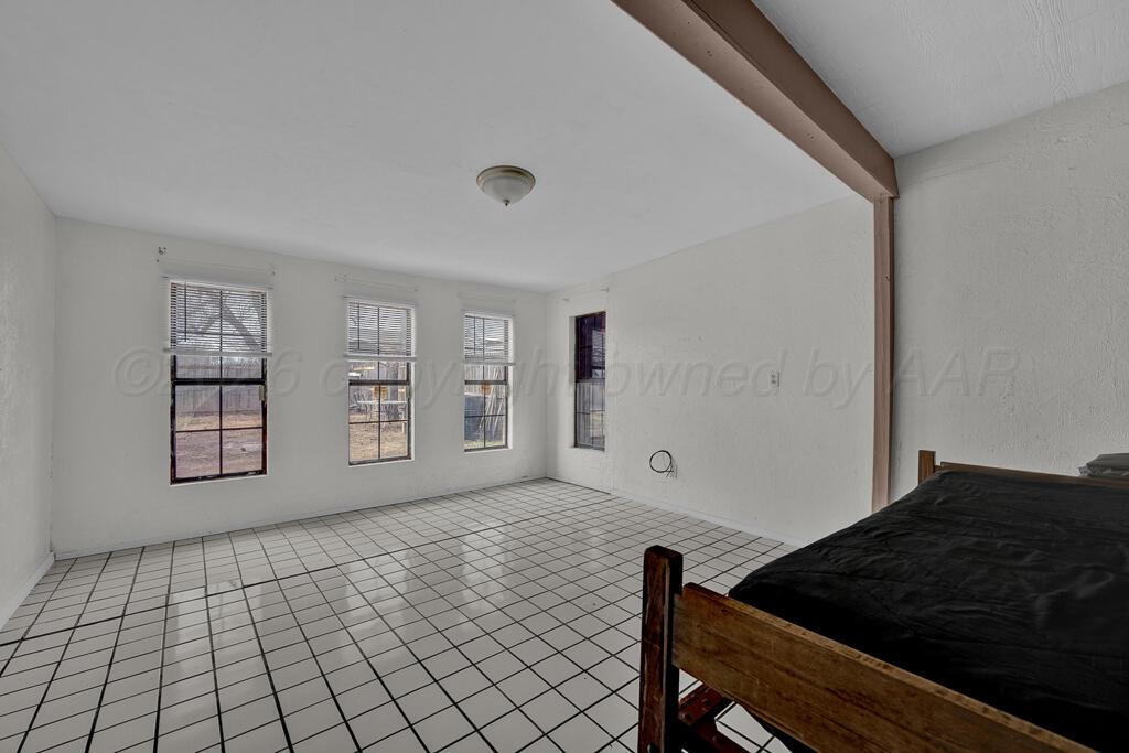 2106 South Cleveland Street Amarillo, TX 79103 - Photo 21 of 26 a bedroom with a bed and a window