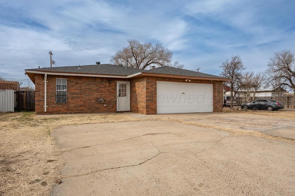 2106 South Cleveland Street Amarillo, TX 79103 - Photo 3 of 26 a front view of a house with a yard and garage