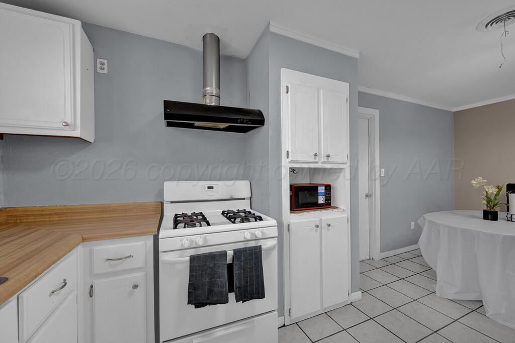 2106 South Cleveland Street Amarillo, TX 79103 - Photo 9 of 26 a kitchen with white cabinets and white appliances