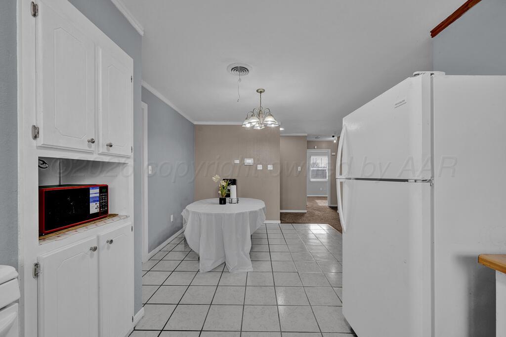 2106 South Cleveland Street Amarillo, TX 79103 - Photo 10 of 26 a kitchen with stainless steel appliances a refrigerator sink and cabinets