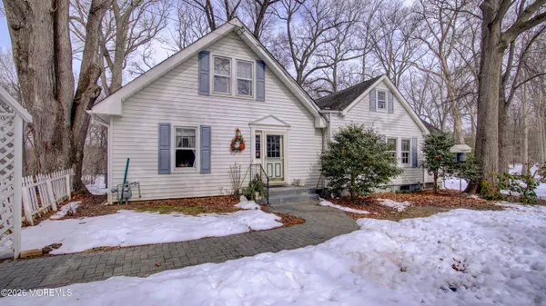 a view of a house with a yard covered in snow